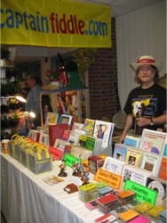 Ryan Thomson running the Captain Fiddle Booth at the New England Folk Festival