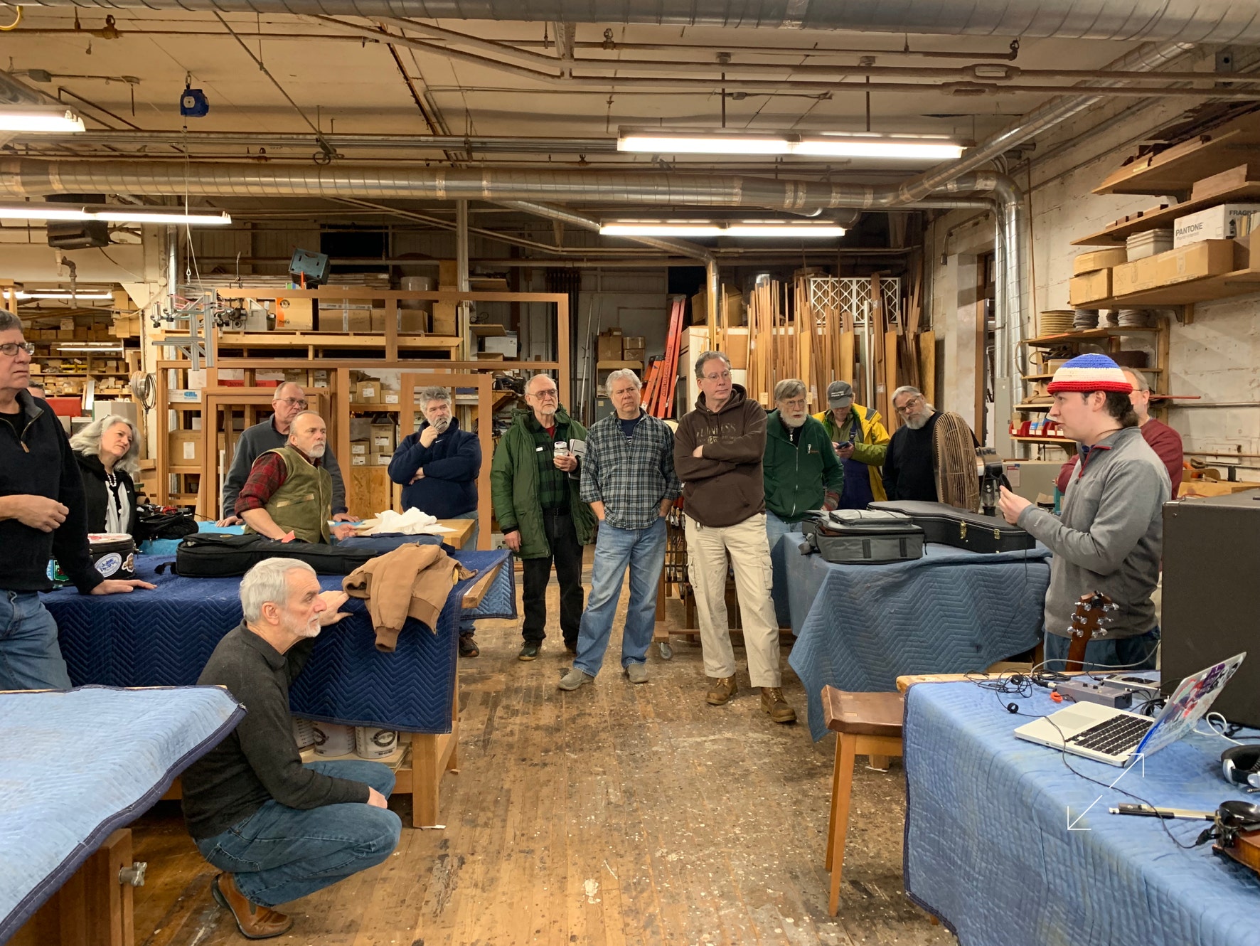 Photo of Brennish Thomson leading a workshop on acoustic instrument amplification using "Your Heaven" equipment, in Somerville, Massachussets.